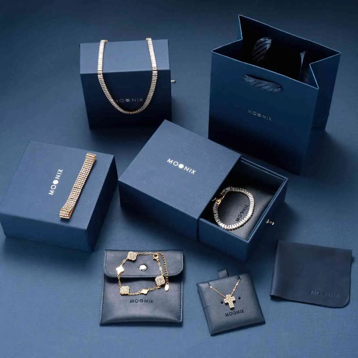 Gold-toned diamond-encrusted bracelet in a navy blue moonix gift box