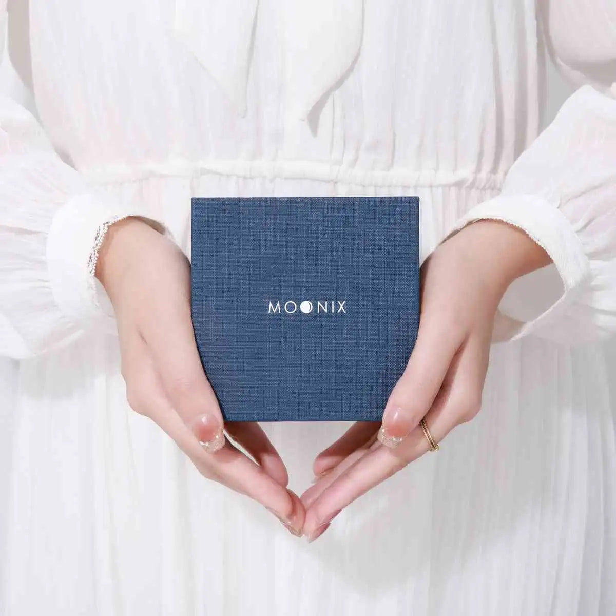 Navy blue textured square box with ’moonix’ logo in white lettering